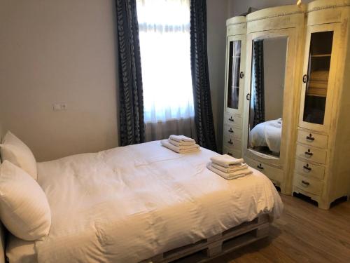 a bedroom with a bed and a dresser and a mirror at Ethno House inn Tianeti in Tʼianetʼi