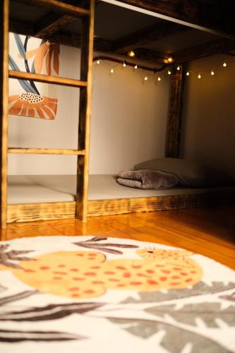 a room with two bunk beds and a rug on the floor at 島隅慢旅 in Xiaoliuqiu