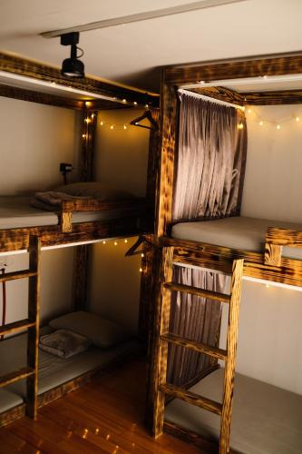 a room with four bunk beds and a ladder at Co Diving Hostel in Xiaoliuqiu