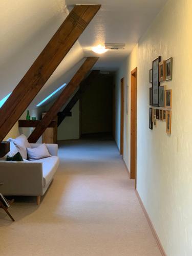 a living room with a white couch in a attic at das Eppelsheimer in Undenheim