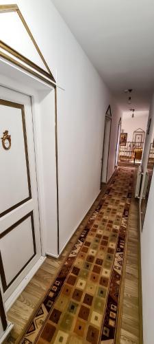 an empty room with a door and a wooden floor at 5 Stars High Hostel in Bucharest