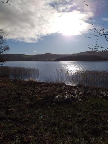 a view of a lake with the sun in the sky at Old School House Belcoo 41 in Belcoo