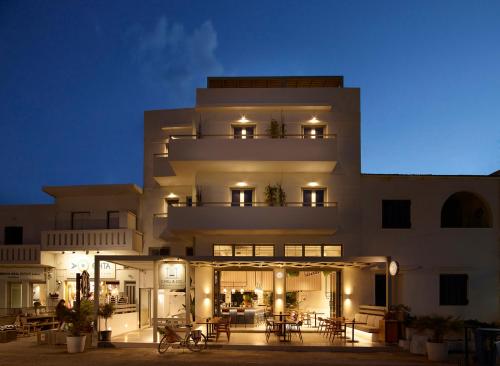 a building with tables and chairs in front of it at Chill & Co. Serifos in Livadion