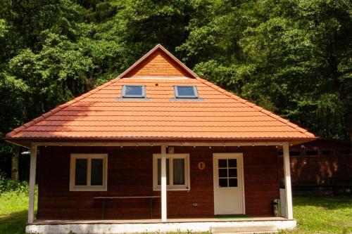 a small house with an orange roof at Tusnad Camping in Băile Tuşnad