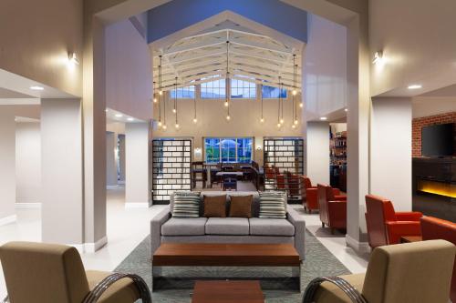 a lobby with a couch and chairs and a fireplace at Four Points by Sheraton Orlando Convention Center in Orlando