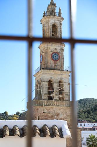 a tall clock tower with a clock on it at EL MIRADOR DE LA TORRE in Constantina