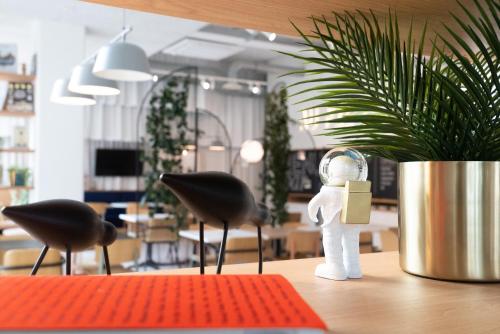 a figurine of a person holding a door on a table at ibis Styles Paris Romainville in Romainville