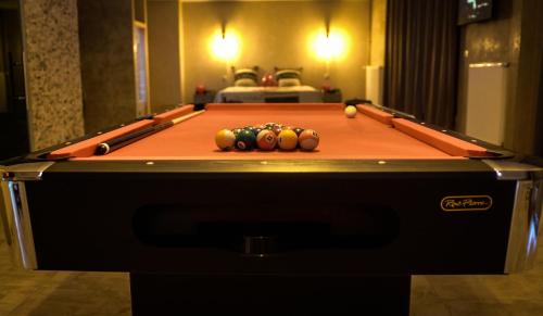 a pool table with balls on top of it at LE LOFT A BULLES (85m2 Jacuzzi Hammam Billiard Bar Douche Sauna) in Strasbourg