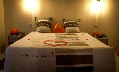 a bedroom with a bed with a heart on it at LE LOFT A BULLES (85m2 Jacuzzi Hammam Billiard Bar Douche Sauna) in Strasbourg