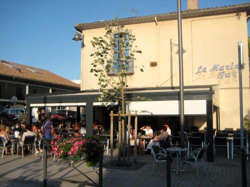 a group of people sitting at tables outside of a building at Marseillan 18th Century 2-Bed House Sleeps 6 in Marseillan