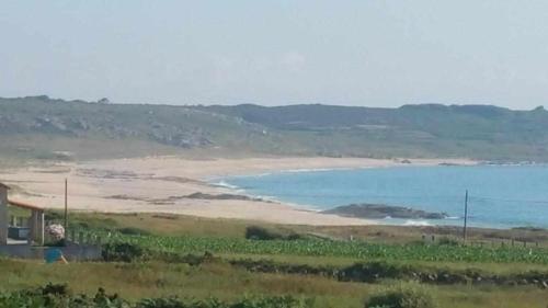 a view of a beach and the ocean at Cubelas Porto do Son in Porto do Son