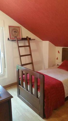 a bedroom with a bed and a ladder and a table at Cubelas Porto do Son in Porto do Son