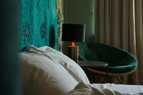 a bedroom with a bed and a chair and a lamp at Edville Home in Ghent