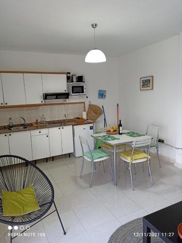 a kitchen with a table and chairs in a room at Apartamento El Carmen 6 in Morro del Jable