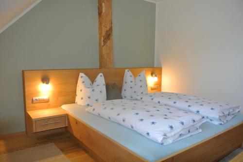 a bedroom with a bed with two pillows on it at Haus Fischer Nassfeldblick in Kirchbach