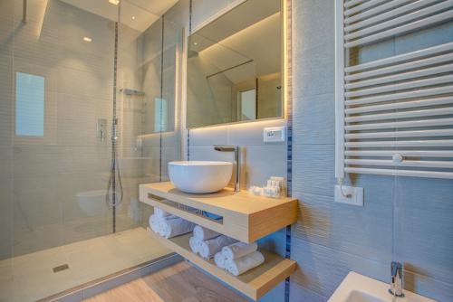 a bathroom with a sink and a glass shower at Hotel San Marco in Cattolica