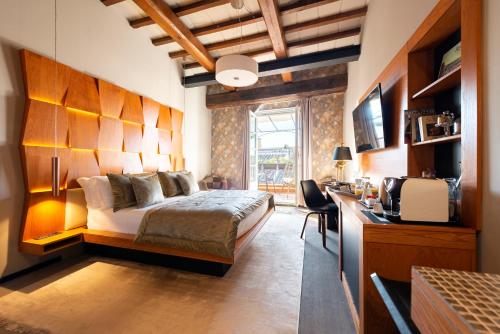 um quarto com uma cama e uma secretária com uma televisão em Ara di Marte Suites em Roma