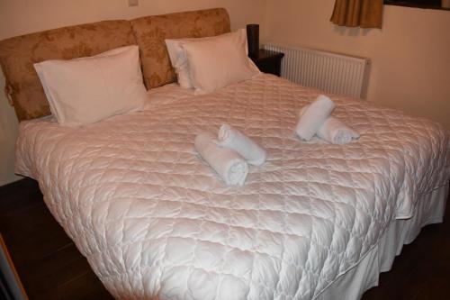 a bed with white sheets and pillows on it at Trikala's Panoramic View Villa in Synikia Mesi Trikalon