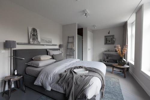 a bedroom with a bed with a blanket on it at Mother Goose Hotel in Utrecht