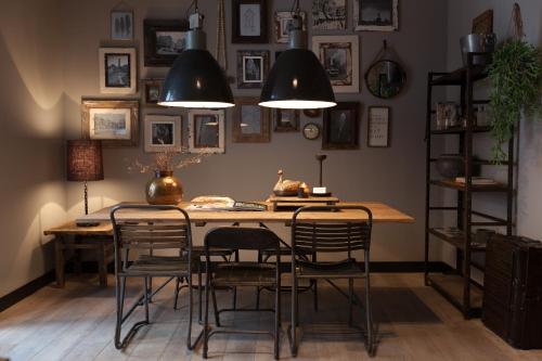 a dining room with a table and chairs and pictures on the wall at Mother Goose Hotel in Utrecht
