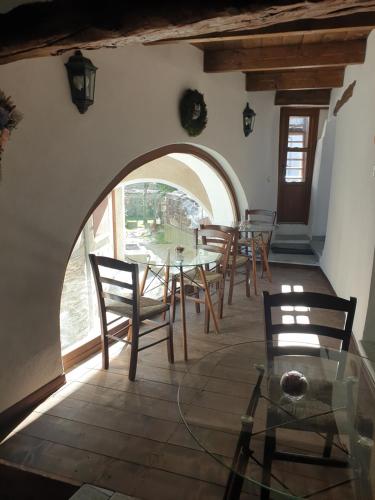 a dining room with a glass table and chairs at Antica casa occitana in Sampeyre