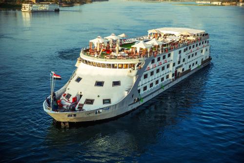 a large cruise ship in the water at Champollion II 5 Stars Nile cruise in Luxor