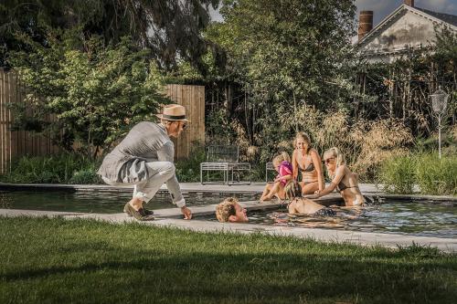 a man playing with a dog in a swimming pool at Edville Home in Ghent