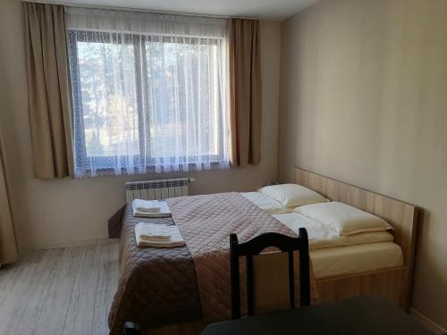 A bed or beds in a room at Borovets Gardens Apartment A27