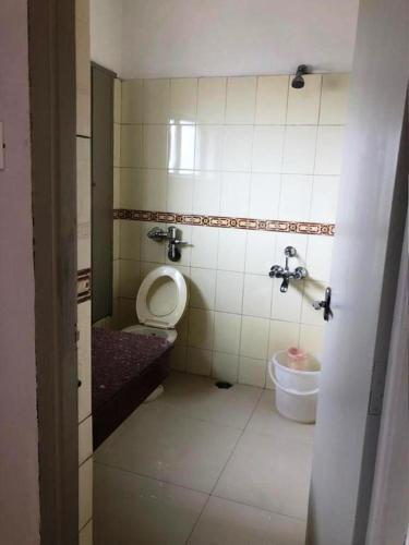 a bathroom with a toilet and a sink at Hotel Preethi Palace in Ooty
