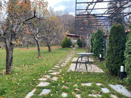 a picnic table in a park with trees at Kot Garden Guest House in Sapareva Banya