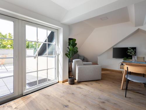 an empty living room with a sliding glass door at Limehome Hannover Bleichenstraße - Digital Access in Hannover
