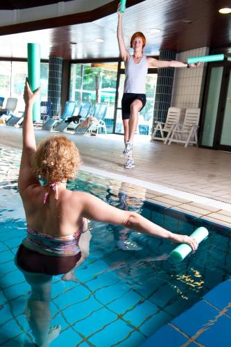 two women playing in a swimming pool at Hotel Toplice - Terme Krka in Smarjeske Toplice