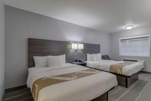 a hotel room with two beds and a window at Quality Inn Kodak Sevierville in Kodak