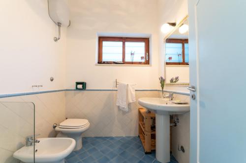 a bathroom with a toilet and a sink at MAIN Roof Terrace Apartment in Nerano