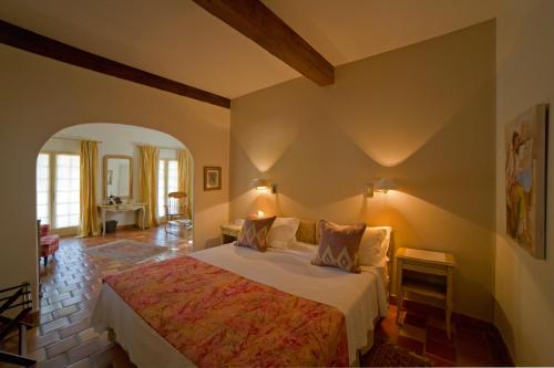 a bedroom with a large bed in a room at Hotel Le Mas Trilles in Céret