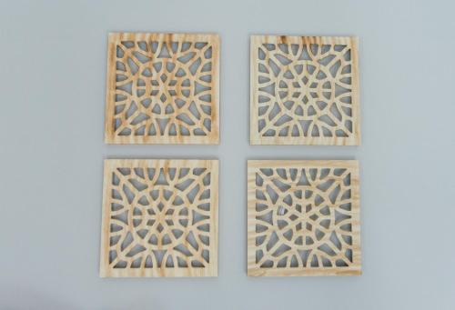 a set of four wooden doors with a pattern on a wall at The Perfect Corner Guesthouse in Bethlehem