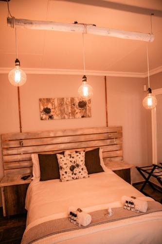 a bedroom with a bed with two towels on it at The Perfect Corner Guesthouse in Bethlehem