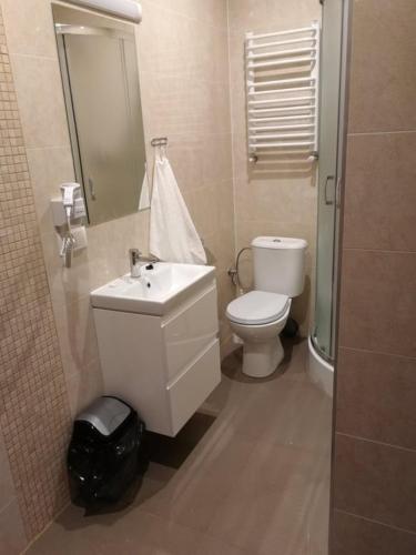 a bathroom with a white toilet and a sink at Zajazd Promyk 