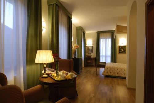 a hotel room with a table with a lamp on it at Zunica Ospitalità dal 1880 in Civitella del Tronto