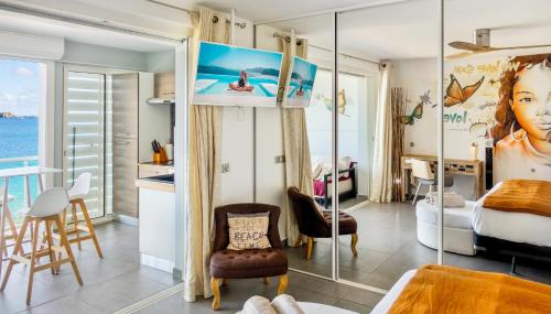 a bedroom with a king bed and a view of the ocean at Residence Bleu Marine - Sea View Apartments & Studios - Saint-Martin French Side in Grand Case
