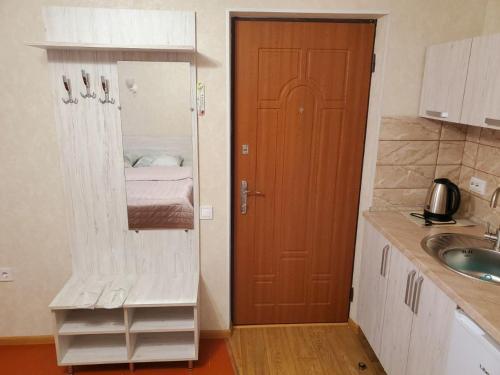 a small kitchen with a door and a sink at Апартаменти "Ілона" в центрі Східниці in Skhidnitsa