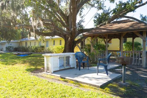 a gazebo with two chairs and a table in a yard at Mar Bay Exclusive Suites in Safety Harbor
