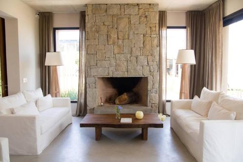 a living room with a couch and a fireplace at Casa Tilo in José Ignacio