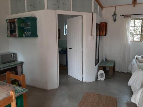 a room with a door open to a bedroom at Over Karoo Inn in Barrydale