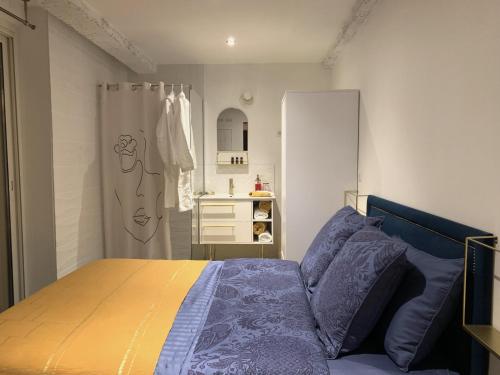 a bedroom with a bed and a bathroom with a sink at Appartement atypique cosy entre terre & mer in Marseille