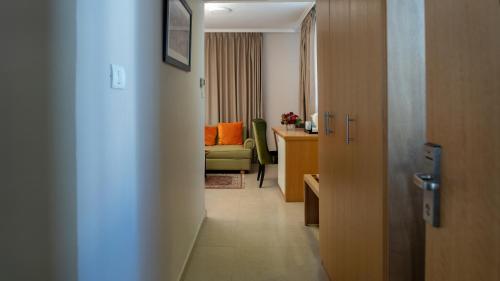 a hallway of a hotel room with a couch at The Sephardic House Hotel in The Jewish Quarter in Jerusalem