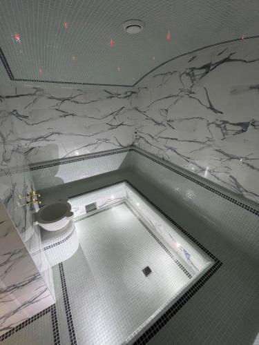 a bathroom with a shower with a toilet in it at In hotel in Kamianets-Podilskyi