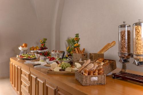a buffet with many baskets of food on a table at The Sephardic House Hotel in The Jewish Quarter in Jerusalem