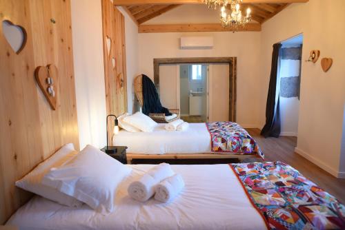 a hotel room with two beds and a mirror at Largo Bispo Boutique Hostel in Horta