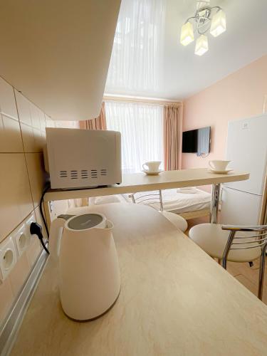 a room with a kitchen with a table and chairs at McApartment in Kharkiv